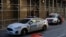FILE - New York City Police Department (NYPD) officers sit in vehicles outside the District Attorney's Office in New York, March 29, 2023. 