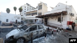 FILE - People inspect the damage at Ahli Arab Hospital in central Gaza on Oct. 18, 2023, following a blast that ripped through it a day earlier. The U.S. and Israel have cast doubt on the veracity of the death tolls being reported by the Hamas-controlled Ministry of Health.