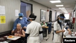 FILE - Nursing home residents receive a coronavirus vaccine at King David Center for Nursing and Rehabilitation, a nursing home facility, in Brooklyn's Bath Beach neighborhood in New York City, Jan. 6, 2021. 