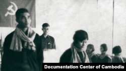 This photograph shows the wedding of Nun Huy aka Huy Sre (left) and Prok Khoeun aka Prak Samuth (right). Huy was born in 1951 and served as head of the Khmer Rouge re-education center at Prey Sar, also known as Office S-24. Prey Sar was part of the central internal security complex in Democratic Kampuchea, which also included Toul Sleng Prison (S-21) and the Killing Fields at Choeung Ek. One prison document, dated 23 July 1977, reports the killing of 18 prisoners at S-24 and bears a note saying "also killed 160 children today for a total of 178 enemies killed." Duch, who oversaw both S-24 and S-21, testified this week that Huy was killed after the escape of his radio operator from Prey Sar. Huy's wife, Prok Khoeun (b. 1953), was an official at S-24 until June 1977, when she became the deputy of an interrogation team known as the "hot group" at Toul Sleng. Source: Documentation Center of Cambodia, Document No. D1175 and K08273. by Dr. John D. Ciorciari.