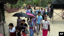 FILE - Karen refugees leave after a church service at Mae La refugee camp in Ta Song Yang district of Tak province, northern Thailand, April 12, 2013. With the end of military rule in Myanmar, aid groups are still working on returning the refugees to Myanmar.