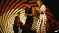 A young couple dance under a psychedelic light show at "The Electric Circus" nightclub in the East Village in New York, in 1967. The "Electric Circus" embodied the wild and creative side of 1960's club culture.