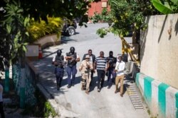 Security forces investigate the perimeters of the residence of Haitian President Jovenel Moise, in Port-au-Prince, Haiti, July 7, 2021. Gunmen assassinated Moise and wounded his wife in their home early Wednesday.