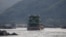 FILE - Chinese cargo ships sail on the Mekong River near the Golden Triangle at the border between Laos, Myanmar and Thailand, March 1, 2016.