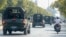 FILE - A convoy of army vehicles patrol the streets in Mandalay, Myanmar, Wednesday, Feb. 3, 2021.