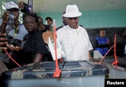 FILE - Joseph Nyuma Boakai, Liberia's vice president and presidential candidate of Unity Party (UP), votes at a polling station in Monrovia.