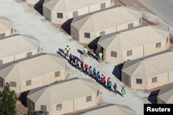 Immigrant children, who have been separated from their families under a now reversed policy by the Trump administration, are being housed in tents next to the Mexican border, in Tornillo, Texas, June 18, 2018. Under President Donald Trump’s newly issued order, the Defense Department would help provide or construct facilities to house families detained on the U.S.-Mexico border.