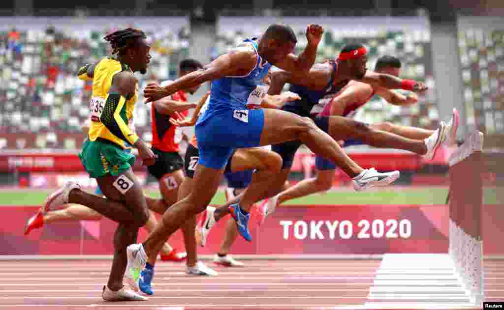 Athletes compete in the men's 110-meter hurdles at the 2020 Summer Olympics in Tokyo, Japan.