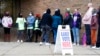People line up outside a polling station to cast their votes in Milwaukee, Wisconsin, Oct. 25, 2022.