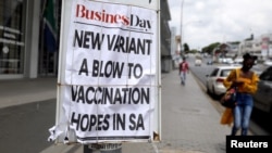 A woman walks past newspaper billboards during the coronavirus disease (COVID-19) outbreak in Johannesburg, South Africa, Feb. 8, 2021. 