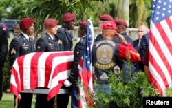 FILE - An honor guard carries the coffin of U.S. Army Sergeant La David Johnson, who was among four special forces soldiers killed in Niger, at a graveside service in Hollywood, Florida, Oct. 21, 2017.