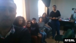 Azerbaijani authorities detain RFE/RL's Baku bureau staff during an office raid, Dec. 26, 2014.