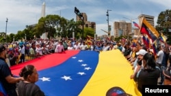 People carry Venezuela's national flag to protest the election results that awarded Venezuela's President Nicolas Maduro with a third term, in Maracaibo, Venezuela, July 30, 2024.