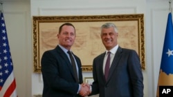 FILE - Kosovo President Hashim Thaci, right, shakes hands with U.S. special envoy for the Kosovo-Serbia dialogue, Ambassador Richard Grenell, in Kosovo's capital of Pristina, Oct. 9, 2019.