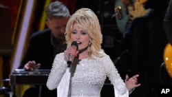 FILE - This Nov. 13, 2019 file photo shows Dolly Parton performing at the 53rd annual CMA Awards in Nashville, Tenn. Parton tweeted Wednesday, April 1, that she’s donating $1 million to Vanderbilt University Medical Center in Nashville, Tennessee.