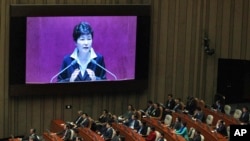 South Korean President Park Geun-hye, shown on a large screen, delivers a speech at the National Assembly in Seoul, South Korea, Oct. 24, 2016.