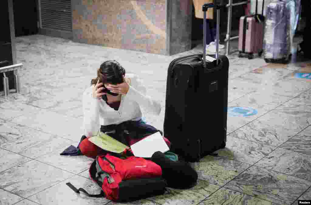 A passenger tries to find a flight as several airlines have stopped flying out of South Africa, amidst the spread of the new SARS-CoV-2 variant Omicron, at O.R. Tambo International Airport in Johannesburg, South Africa.
