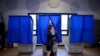 FILE - A voter leaves the booth after casting her ballot in the Pennsylvania primary at a polling place in Philadelphia, Pa., April 26, 2016.