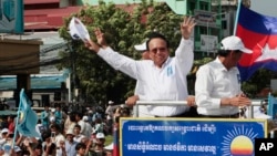 FILE - In this June 2, 2017, file photo, opposition party Cambodia National Rescue Party (CNRP) leader Kem Sokha greets his supporters at a rally in Phnom Penh, Cambodia. 