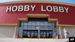 Customers walk to a Hobby Lobby store in Oklahoma City, June 30, 2014. 