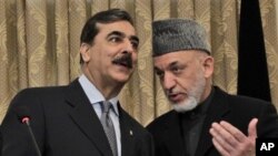 Pakistan's Prime Minister Yousuf Raza Gilani, left, speaks with Afghanistan's President Hamid Karzai during a news conference in Kabul, Afghanistan, April 16, 2011