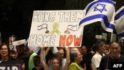 Rodbina i pristalice podižu plakate s porukama i portretima izraelskih talaca držanih u Gazi od napada Hamasa 7. oktobra u južnom Izraelu, tokom skupa na kojem se poziva na njihovo oslobađanje, ispred ureda premijera u Jerusalimu 22. maja 2024.