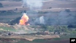 This image taken from a video released by Armenian Defense Ministry on Monday, Sept. 28, 2020 allegedly shows fighting between Armenian and Azerbaijani forces.