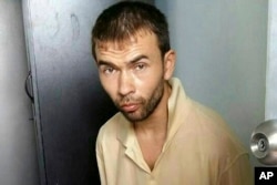 FILE - This image released by the Royal Thai Police shows a man who was arrested at an apartment on Aug. 29, 2015, in Bangkok, along with evidence police said included bomb-making equipment.