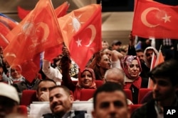 Supporters of Turkey's President and ruling Justice and Development Party leader Recep Tayyip Erdogan wave flags as they listen to him speak during an election rally in Istanbul, Turkey, May 29, 2018.