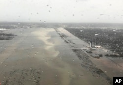 This Monday, Sept. 2, 2019 photo released by the U.S. Coast Guard Station Clearwater, shows flooding on the runway of the Marsh Harbour Airport in the Bahamas.