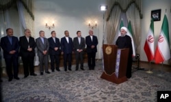 In this photo released by official website of the office of the Iranian presidency, President Hassan Rouhani addresses the nation in a televised speech in Tehran, May 8, 2018.