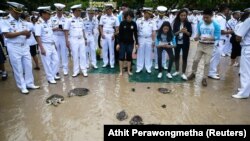 Well-wishers release sea turtles at the Sea Turtle Conservation Center as part of the celebrations for the upcoming 65th birthday of Thai King Maha Vajiralongkorn, also known as King Rama X.
