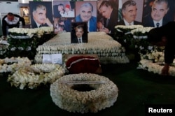 FILE - Wreaths and pictures of Lebanon's former Prime Minister Rafik al-Hariri are seen at his gravesite in downtown Beirut, Feb. 14, 2013.