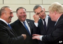 From left, Turkish Foreign Minister Mevlut Cavusoglu, U.S. Secretary of State Mike Pompeo, NATO Secretary-General Jens Stoltenberg and British Foreign Secretary Boris Johnson speak prior to a meeting of NATO foreign ministers at NATO headquarters in Brussels, April 27, 2018.