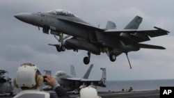 FILE - A U.S. Navy's F/A-18 Super Hornet fighter approaches the deck of the USS Carl Vinson during a joint military exercise between South Korea and the United States, March 14, 2017.
