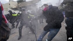 Trump supporters try to break through a police barrier, Wednesday, Jan. 6, 2021, at the Capitol in Washington. As Congress prepares to affirm President-elect Joe Biden's victory, thousands of people have gathered to show their support for President Donald