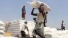 FILE - Men deliver U.N. World Food Programme (WFP) aid in Aslam, Hajjah, Yemen, Sept. 21, 2018.