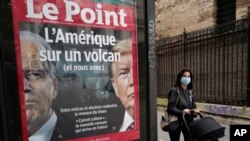 The front page of French weekly newspaper Le Point displays a photo of President Donald Trump and Democratic presidential candidate former Vice President Joe Biden with a headline reading "America on a volcano, (and Us too)" in Paris, Wednesday Sept. 30, 