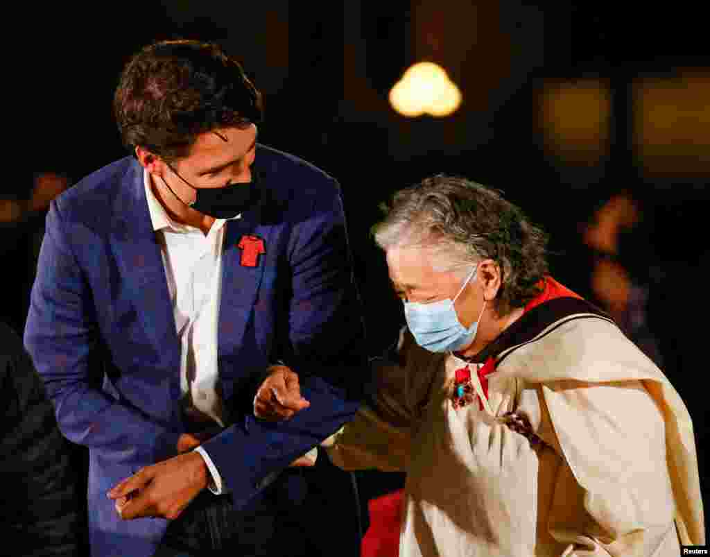 Prime Minister Justin Trudeau escorts Inuk survivor Elder Levinia Brown on the eve of Canada's first National Day for Truth and Reconciliation, honoring the lost children and survivors of Indigenous residential schools, their families and communities on Parliament Hill in Ottawa, Ontario, Sept. 29, 2021
