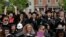 FILE - Graduating seniors react during Commencement ceremonies at Smith College in Northampton, Massachusetts, May 21, 2017