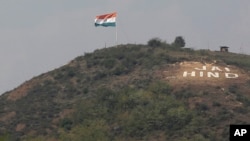 FILE - An Indian flag flies on a hill in the Uri sector, near the de facto border dividing Kashmir between India and Pakistan, in Indian-controlled Kashmir, Sept. 21, 2016. "Jai Hind" roughly translates into "Long live India."