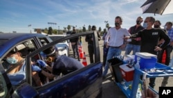 FILE - In this Jan. 15, 2021, file photo, Los Angeles Mayor Eric Garcetti, right, and Governor Gavin Newsom tour the mass COVID-19 vaccination site at Dodger Stadium in Los Angeles. (AP)
