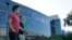 FILE - Two men walk past a building on the Google campus in Mountain View, California. 
