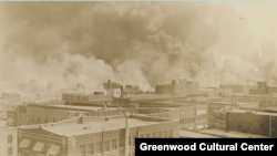 Black Wall Street burns in Tulsa, Oklahoma, June 1, 1921. (Courtesy Greenwood Cultural Center)
