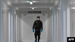 An Institutional Protection Service staffer walks during the inauguration of the new Panama Solidario hospital for seriously ill COVID-19 patients in Panama City, Panama, April 16, 2020.