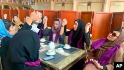FILE - Women gather to demand their rights under the Taliban rule during a protest in Kabul, Afghanistan, Sept. 4, 2021. The Taliban have promised an inclusive government and a more moderate form of Islamic rule than when they last ruled the country.