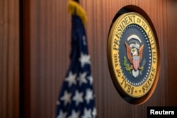 The U.S. Presidential Seal is seen mounted on a wall of the newly renovated White House Situation Room, in a White House handout photo taken in the West Wing of the White House in Washington. U.S. August 16, 2023. Carlos Fyfe/The White House/Handout via Reuters