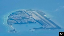Chinese structures and buildings at the man-made island on Mischief Reef at the Spratlys group of islands in the South China Sea are seen on March 20, 2022.