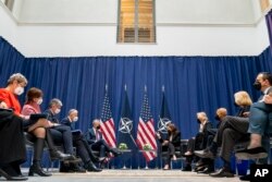 U.S. Vice President Kamala Harris, center-right, meets with NATO Secretary General Jens Stoltenberg, center-left, during the Munich Security Conference, in Munich, Germany, Feb. 18, 2022.