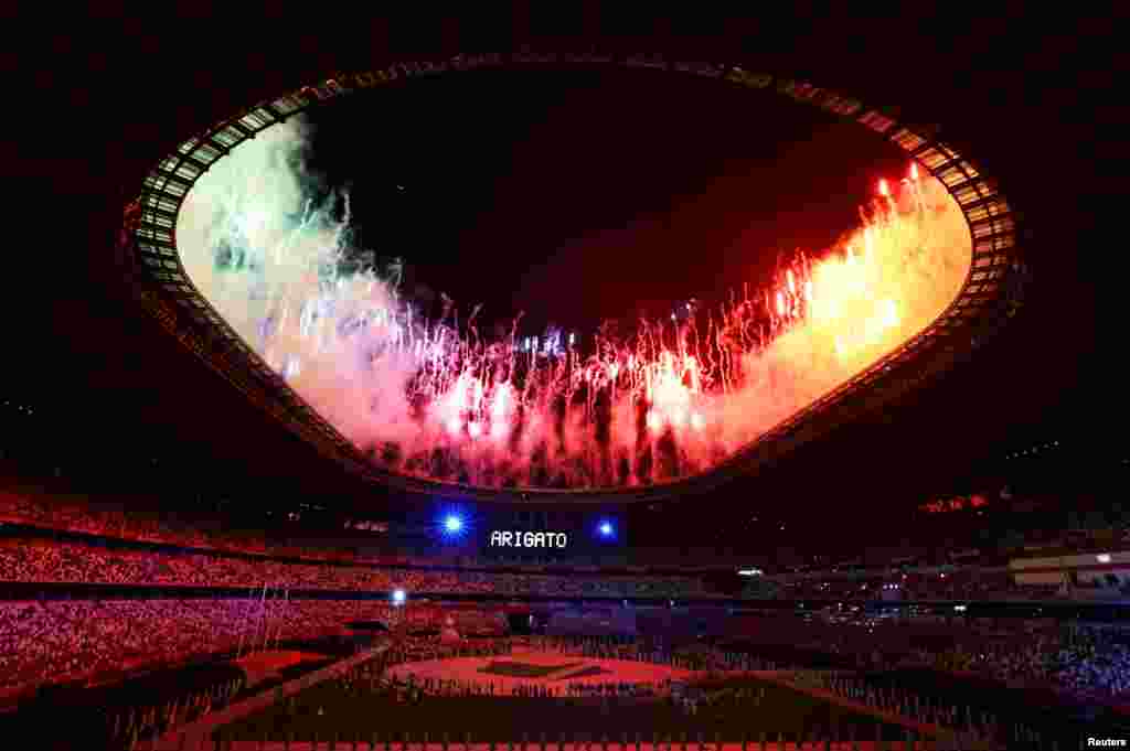 Fireworks explode as a sign that says "Thank You" is displayed at the end of the closing ceremony of the Tokyo 2020 Olympics in Tokyo, Japan.